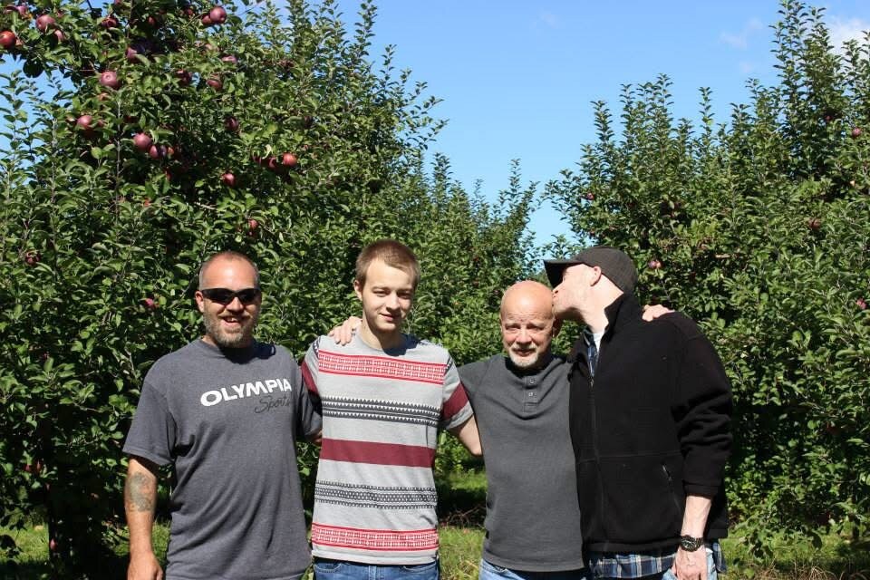 Three men standing together outdoors